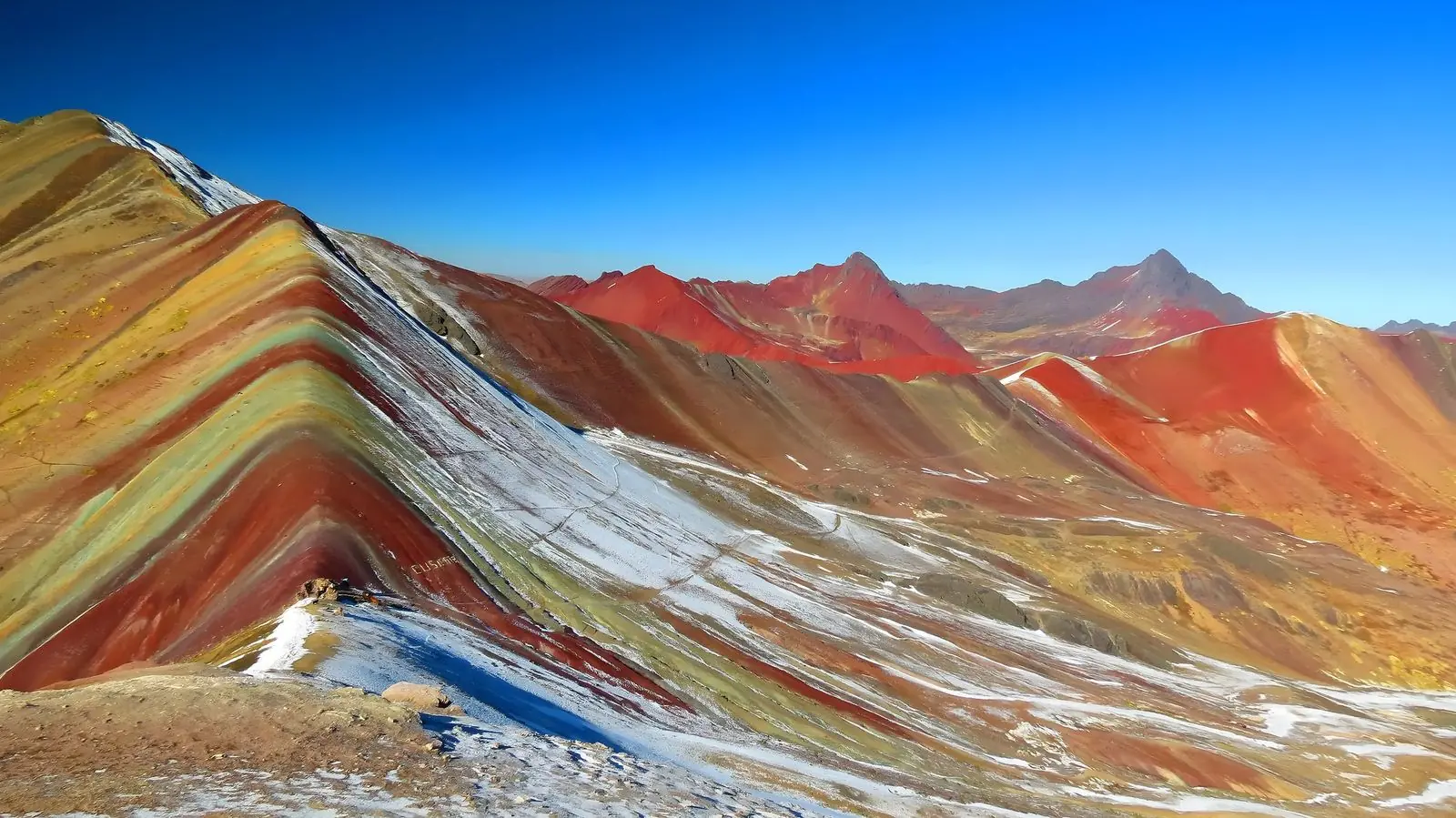 Striped slopes of Rainbow Mountain dusted with snow, the last stop of the 4-day Ausangate trek