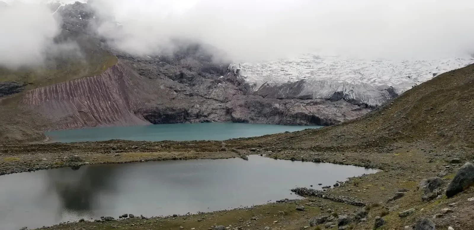 The Ausangate lagoon below the glacier and its striped moraine, night 3 of the 5-day circuit