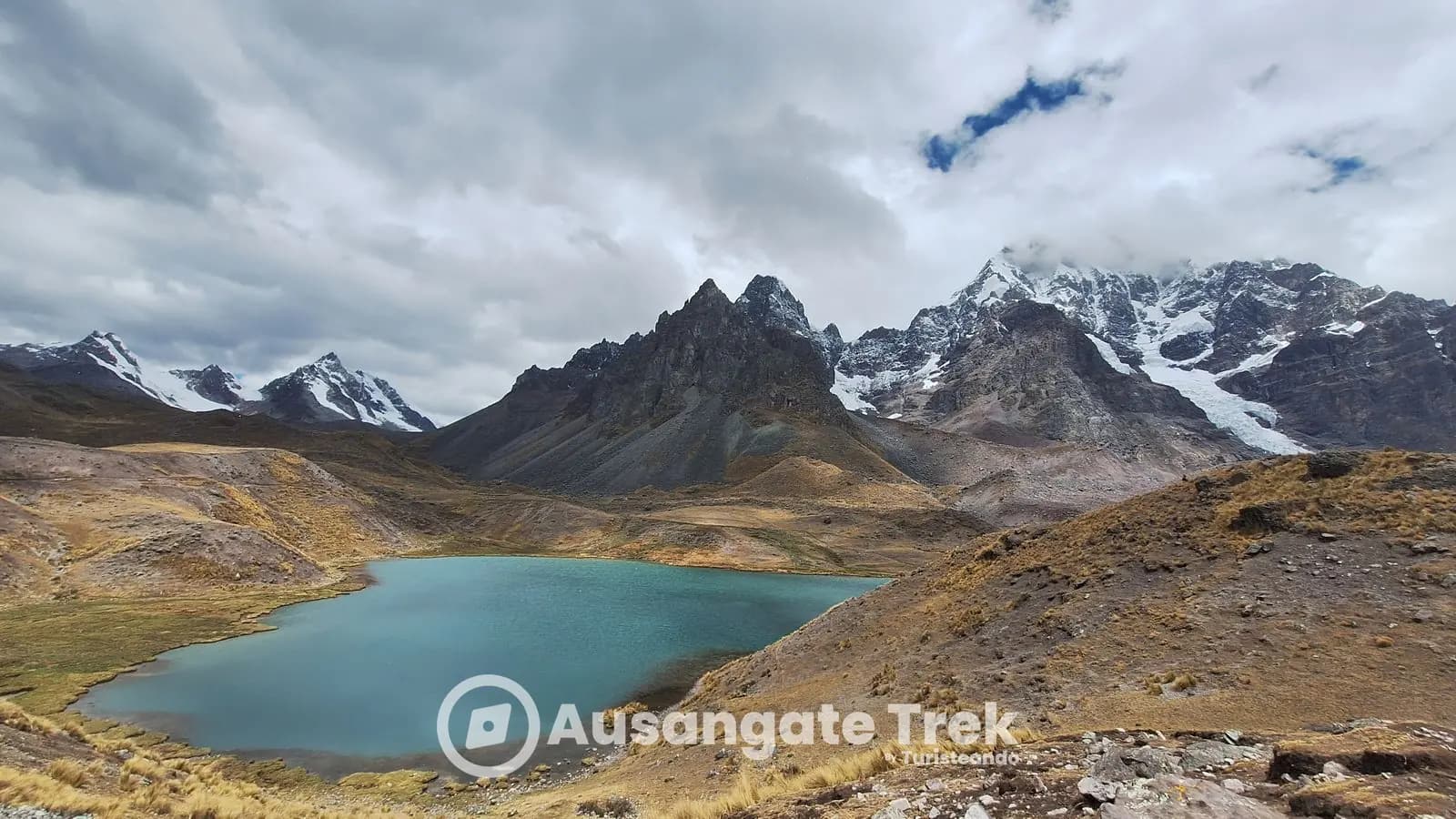 Turquoise Oqe Qocha lake below the glaciers of Ausangate on the 7 Lakes hike